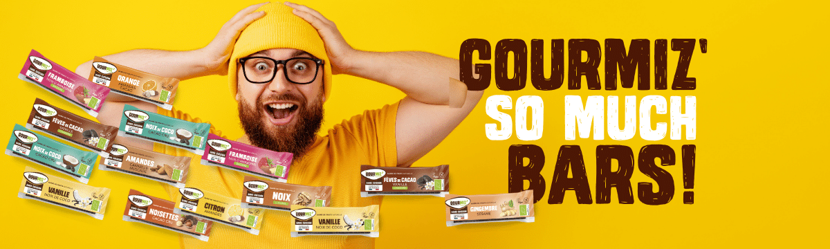 A happy man is surrounded by Gourmiz' energy bars. The picture says: Gourmiz' so much bars